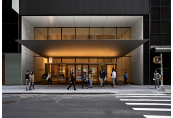 Visitors outside the Museum of Modern Art entrance at night
