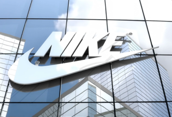 Nike logo on a glass corporate building, representing the importance of keeping brand assets, product images, templates and messaging consistent across enterprise teams and channels