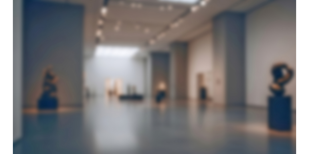 Interior view of a contemporary exhibition space showcasing various sculptural forms