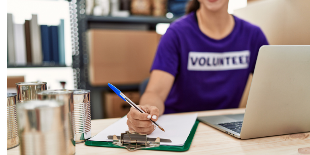 Nonprofit volunteer using a laptop, representing digital asset management for nonprofit teams, campaign assets and mission-driven content