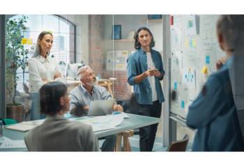 Marketing and sales team reviewing product launch materials, representing how DAM supports manufacturing content, dealer networks and sales enablement workflows
