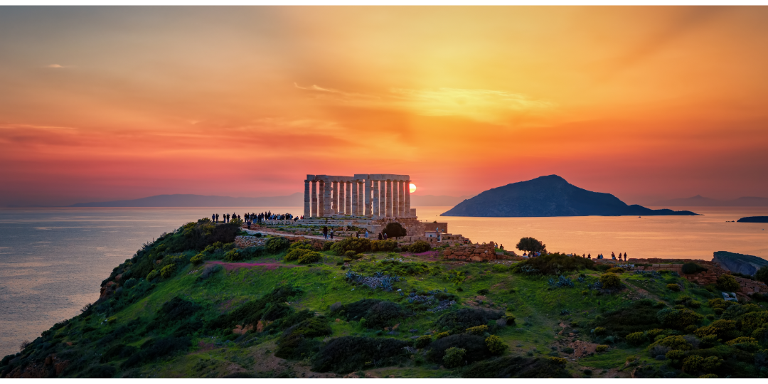 Temple of Poseidon overlooking the Aegean See at sunset in Cape Sounion, Greece.